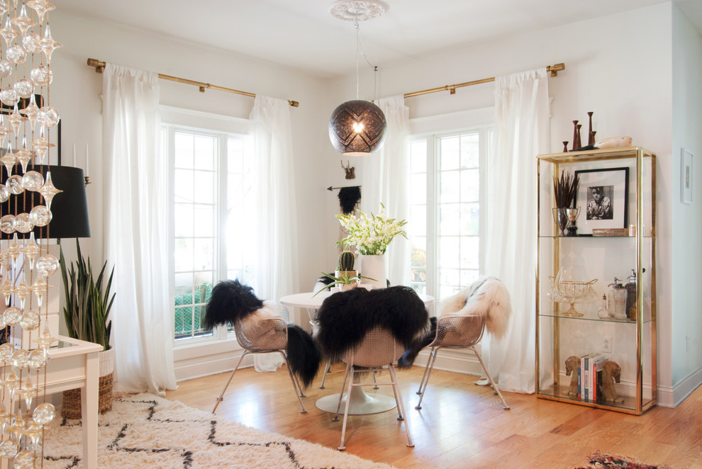 Great room - large eclectic medium tone wood floor great room idea in Cleveland with white walls and no fireplace