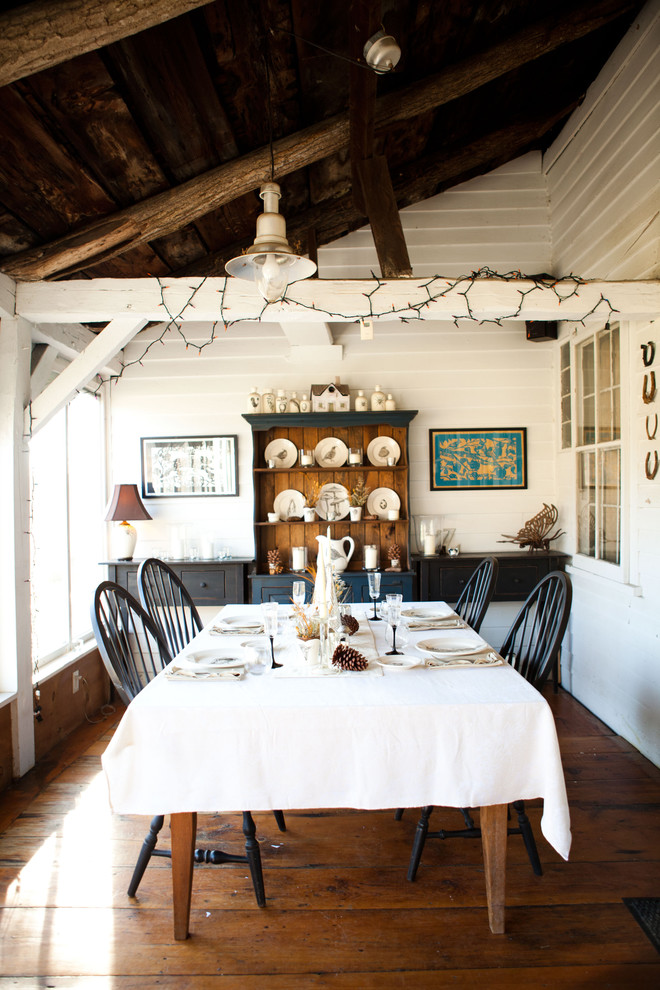 Inspiration for a cottage dark wood floor dining room remodel in Burlington with white walls