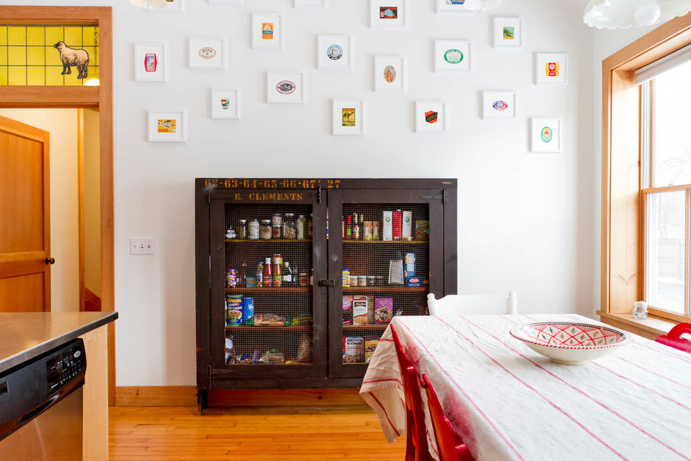Inspiration for an eclectic medium tone wood floor dining room remodel in New York with white walls
