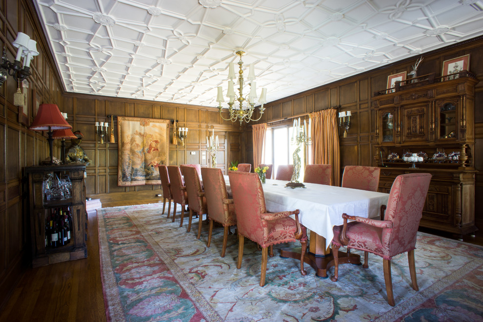 Example of a classic medium tone wood floor enclosed dining room design in San Francisco with brown walls and no fireplace