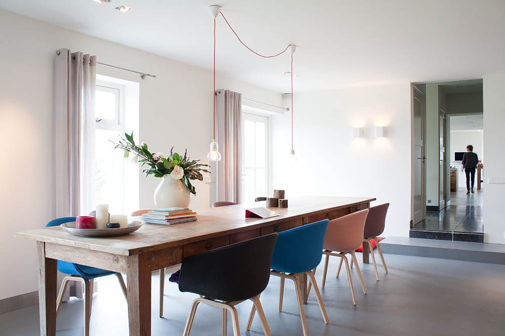 Contemporary dining room in Amsterdam with white walls.