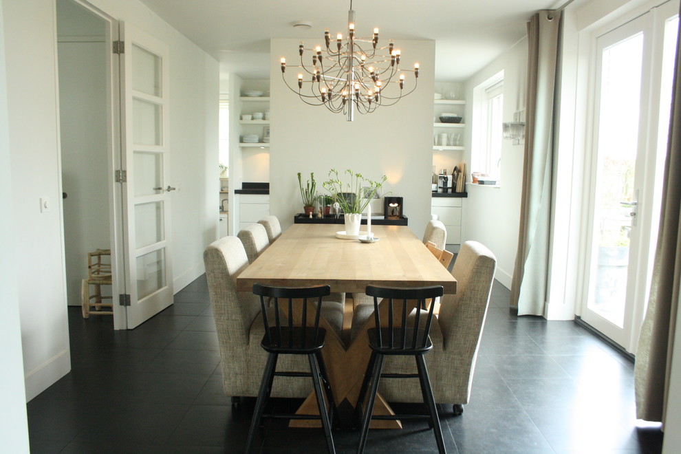 Contemporary dining room in Amsterdam with white walls.