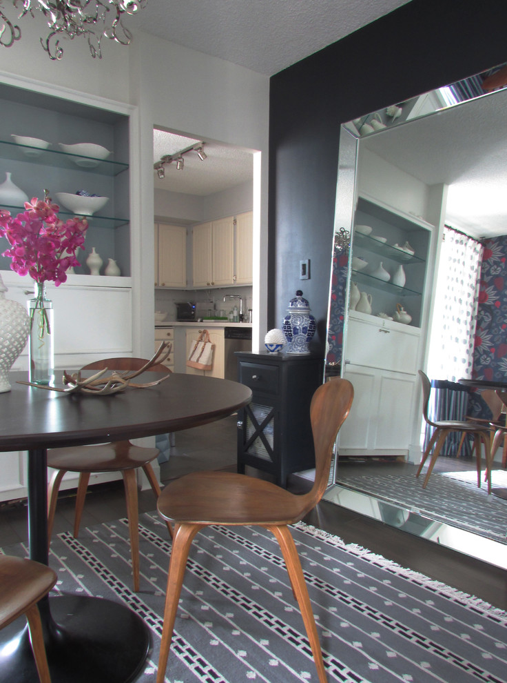 This is an example of a contemporary dining room in Toronto with black walls.