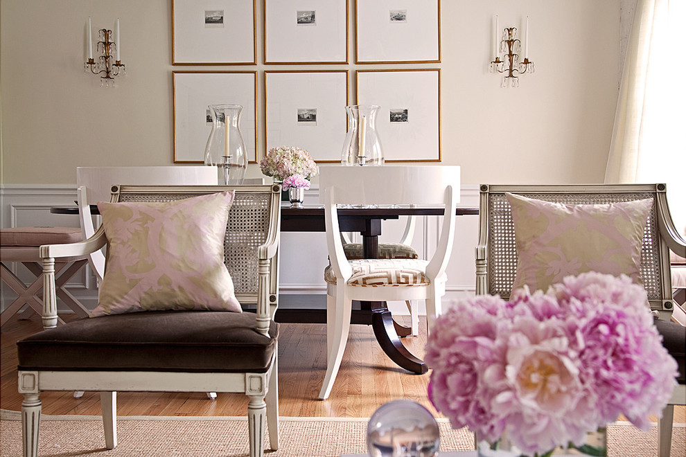 Elegant medium tone wood floor dining room photo in Los Angeles with beige walls