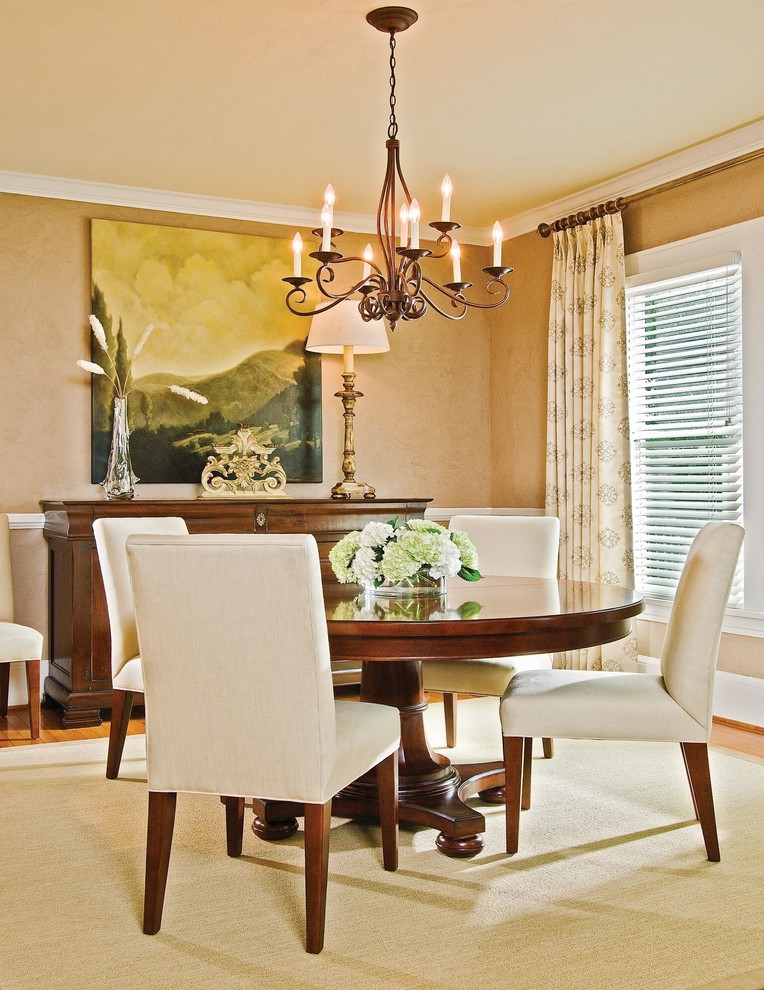 Example of a mid-sized transitional light wood floor and beige floor enclosed dining room design in Charlotte with beige walls and no fireplace