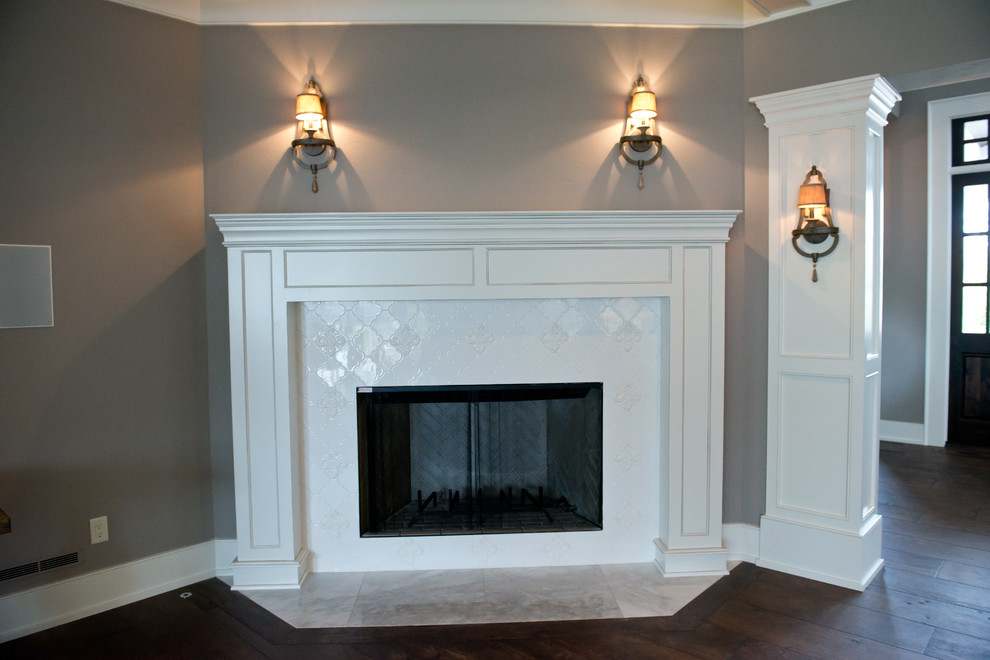 Photo of a large rural enclosed dining room in Milwaukee with grey walls, dark hardwood flooring, a corner fireplace and a tiled fireplace surround.
