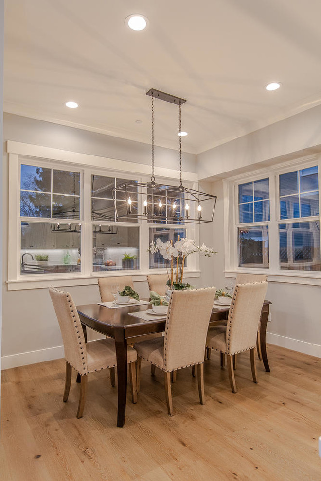 Example of a mid-sized country light wood floor and beige floor kitchen/dining room combo design in San Francisco with gray walls and no fireplace
