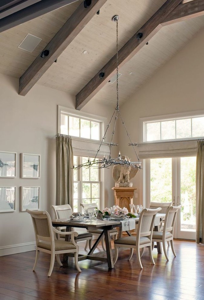This is an example of a large country open plan dining room in San Francisco with beige walls and medium hardwood flooring.
