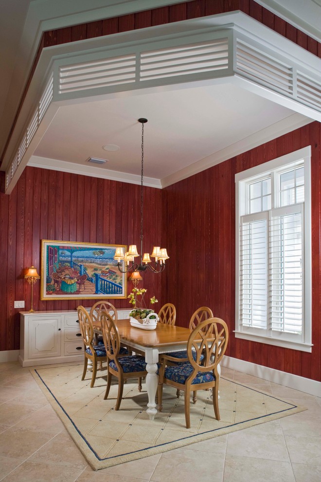 Imagen de comedor tropical con paredes rojas