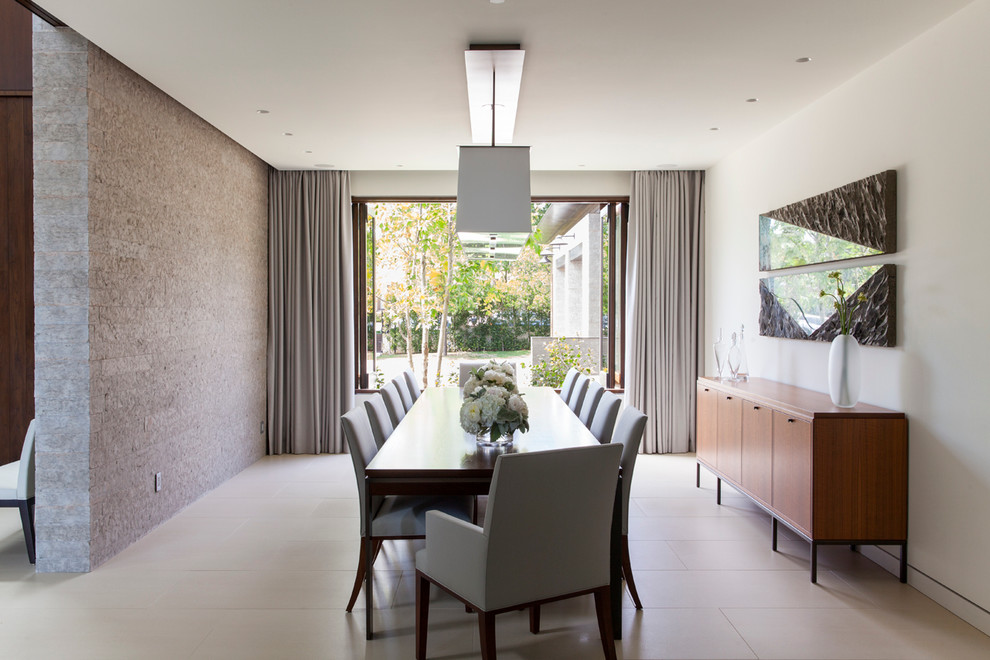Large trendy porcelain tile and beige floor enclosed dining room photo in Los Angeles with white walls