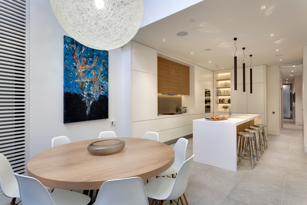This is an example of a contemporary dining room in London with no fireplace and white walls.