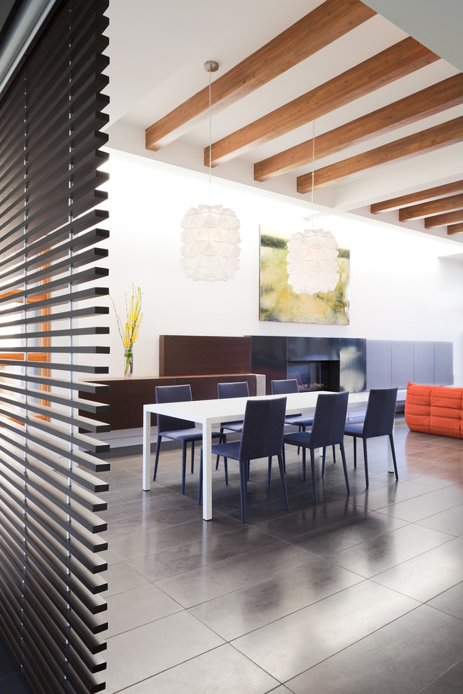 This is an example of a contemporary dining room in Vancouver with white walls.