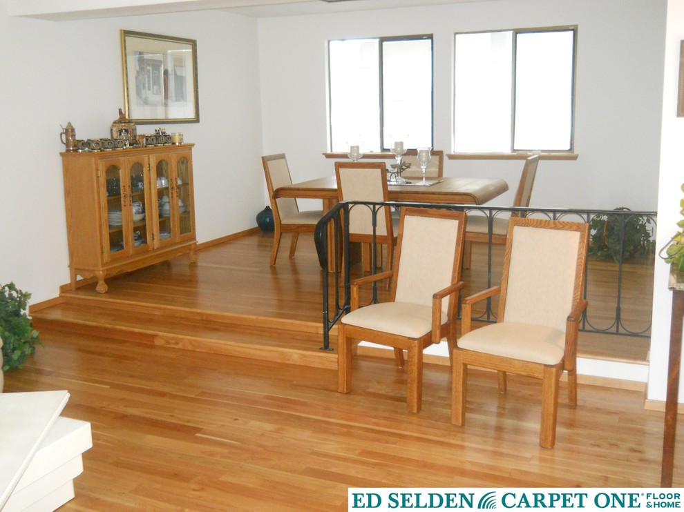 Example of a large classic light wood floor enclosed dining room design in Seattle with white walls and no fireplace