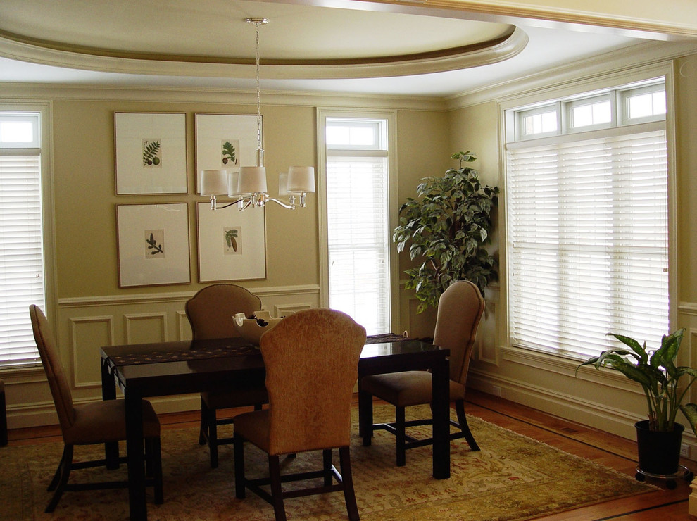 Mid-sized elegant medium tone wood floor and brown floor enclosed dining room photo in Bridgeport with beige walls and no fireplace
