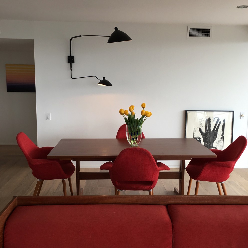 Medium sized midcentury kitchen/dining room in Los Angeles with white walls, light hardwood flooring, no fireplace and brown floors.