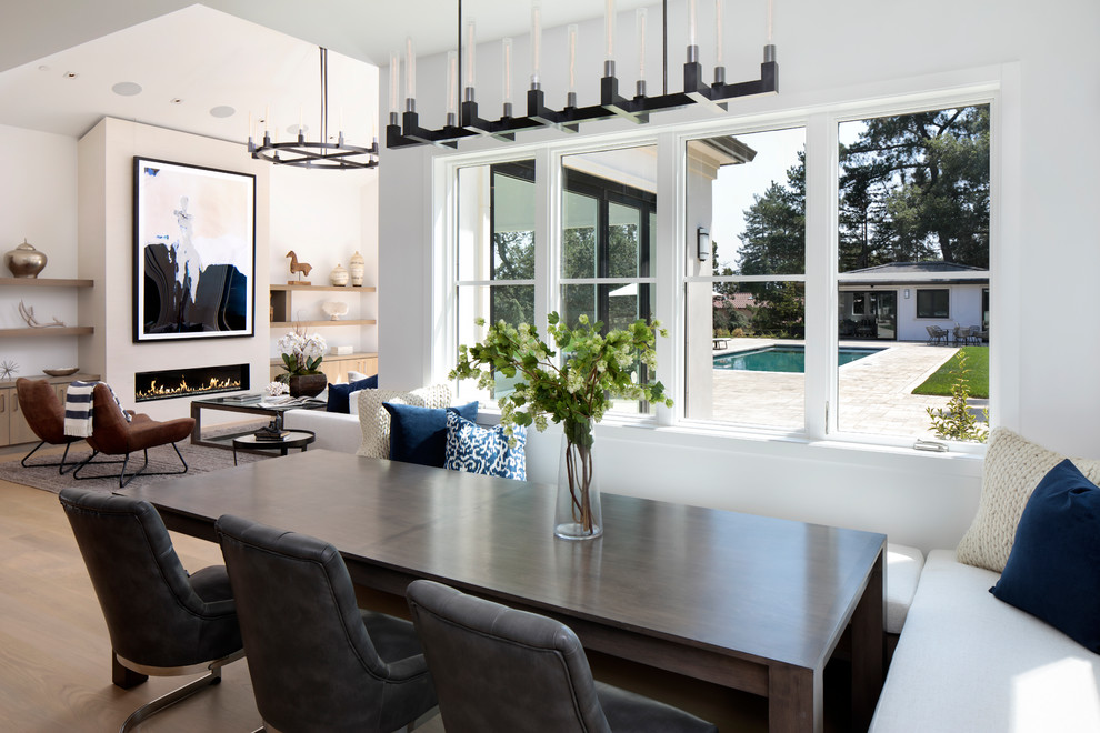 Стильный дизайн: гостиная-столовая в стиле неоклассика (современная классика) с белыми стенами, паркетным полом среднего тона, горизонтальным камином и коричневым полом - последний тренд