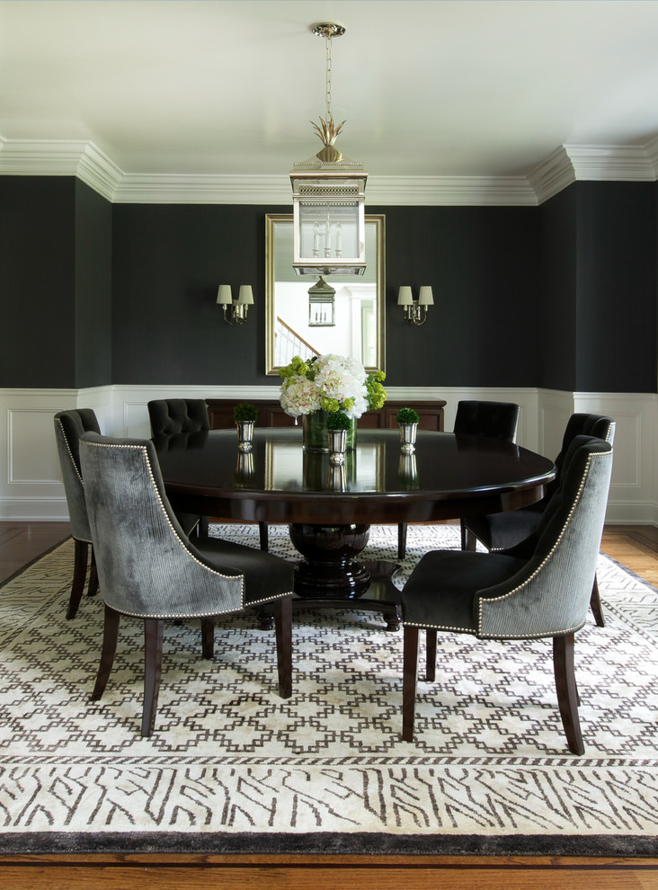 Inspiration for a large traditional enclosed dining room in New York with black walls, medium hardwood flooring and no fireplace.