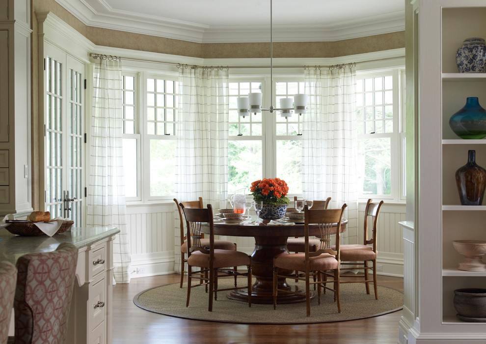 Traditional dining room in New York with beige walls and dark hardwood flooring.