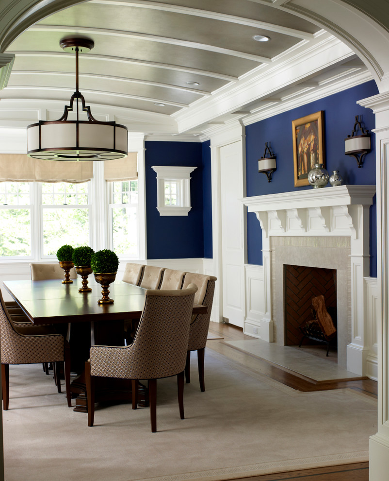 Large elegant medium tone wood floor enclosed dining room photo in New York with blue walls
