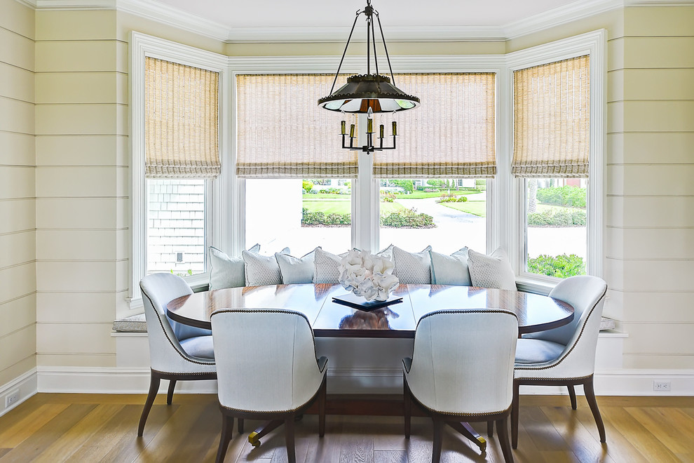 Design ideas for a classic open plan dining room in Jacksonville with medium hardwood flooring, beige walls and brown floors.