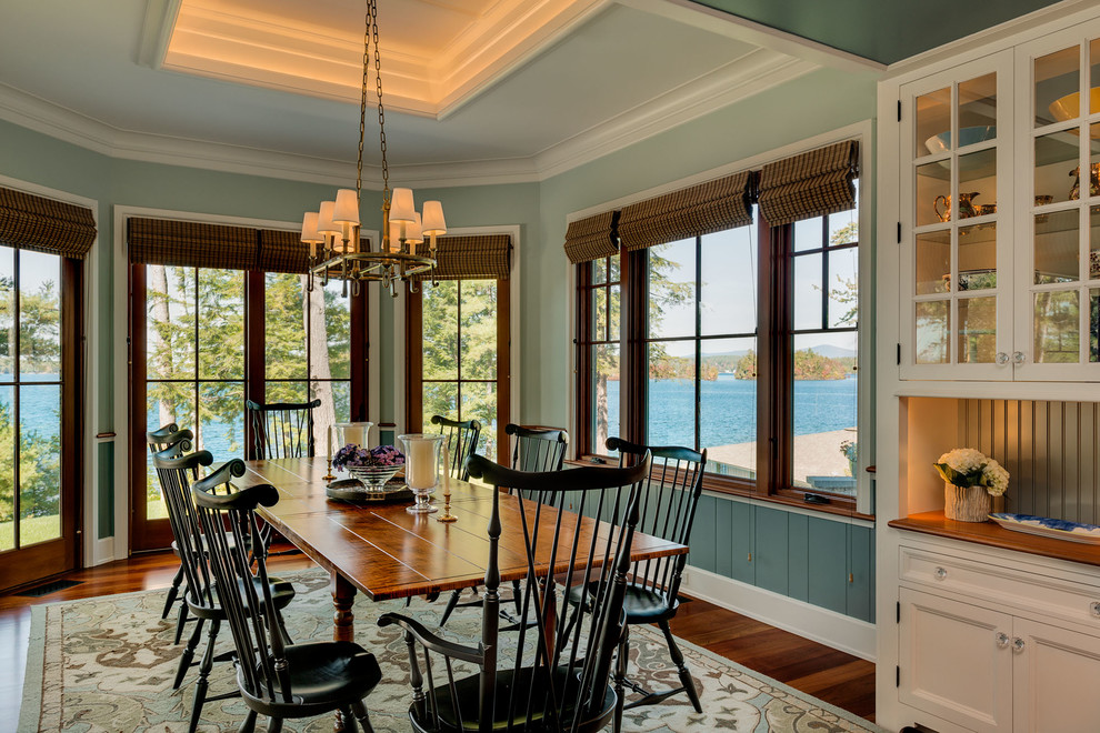 Classic dining room in Boston with blue walls and dark hardwood flooring.
