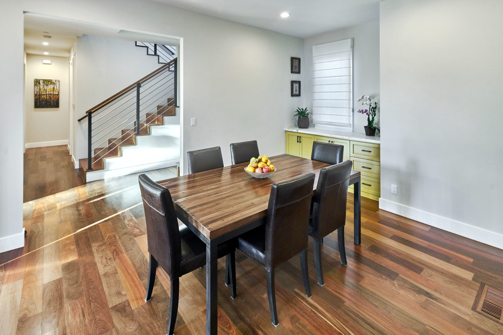Example of a mid-sized transitional medium tone wood floor and brown floor enclosed dining room design in San Francisco with gray walls and no fireplace
