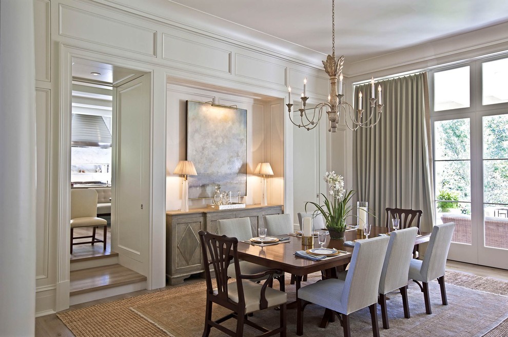 Example of a mid-sized transitional light wood floor and beige floor enclosed dining room design in Charlotte with white walls and no fireplace