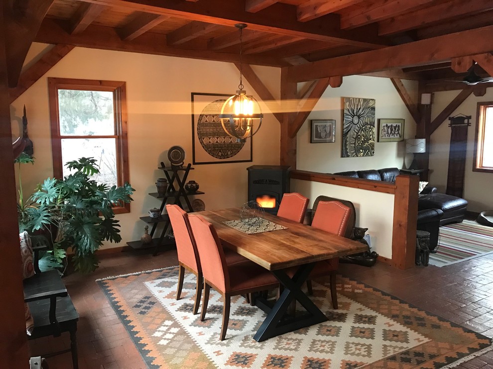 Example of a mid-sized mountain style brick floor and brown floor great room design in Albuquerque with white walls and no fireplace