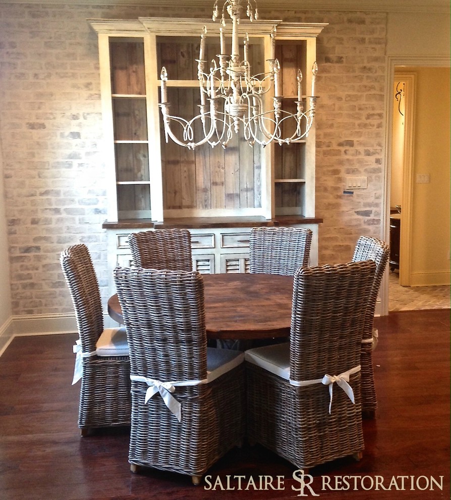 This is an example of a medium sized traditional kitchen/dining room in New Orleans with dark hardwood flooring.