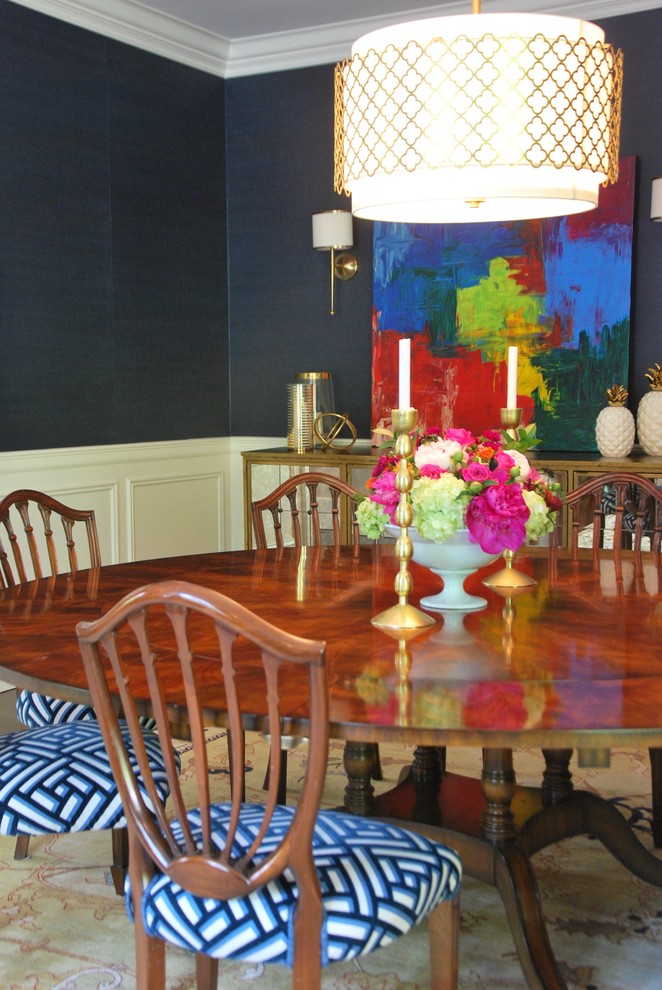 Example of a large classic medium tone wood floor and brown floor enclosed dining room design in New York with blue walls and no fireplace