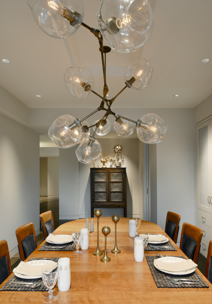 Photo of a classic dining room in New York with grey walls and dark hardwood flooring.