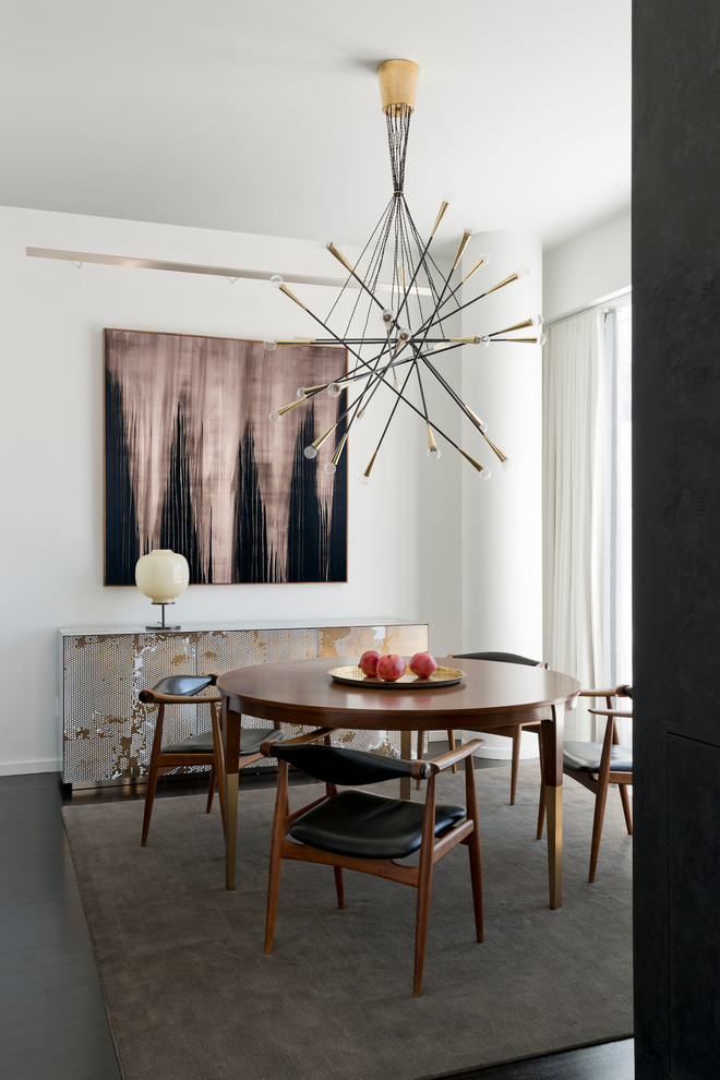 This is an example of a small contemporary open plan dining room in New York with white walls, dark hardwood flooring, no fireplace and brown floors.