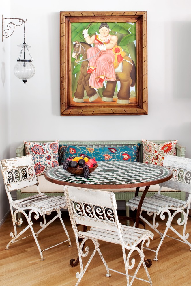 Inspiration for a country medium tone wood floor dining room remodel in New York with white walls