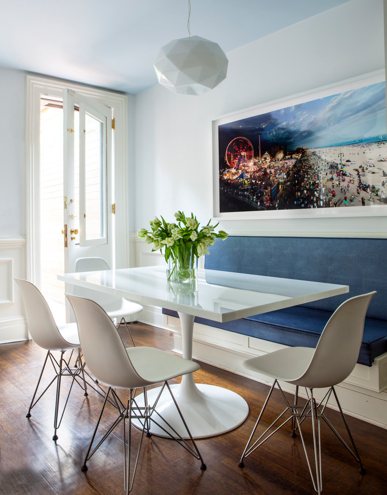 Inspiration for a contemporary dining room in New York with white walls and dark hardwood flooring.