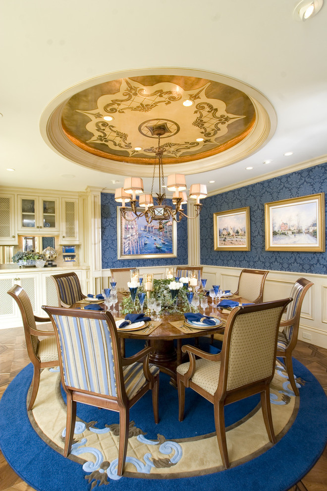 Traditional dining room in Los Angeles with blue walls and dark hardwood flooring.