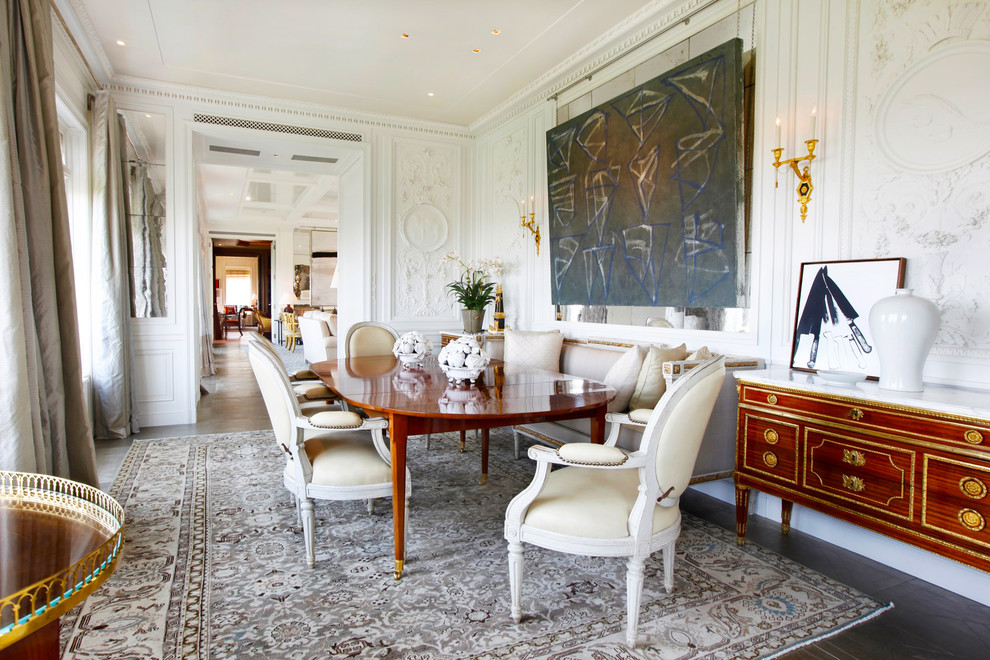 This is an example of a large classic enclosed dining room in Los Angeles with white walls, no fireplace, dark hardwood flooring and brown floors.