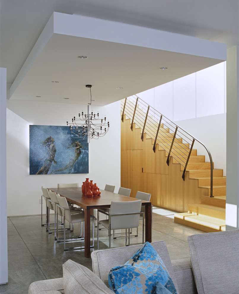 На фото: гостиная-столовая среднего размера в стиле модернизм с белыми стенами, бетонным полом и серым полом без камина с