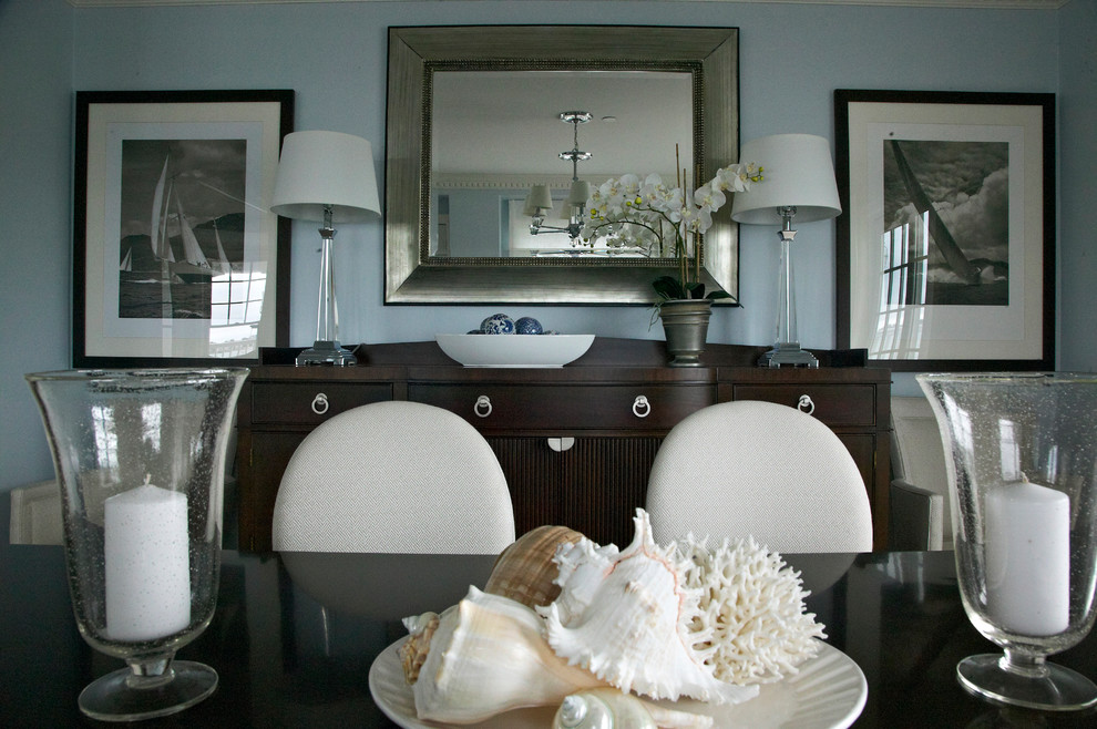 This is an example of a nautical dining room in New York with feature lighting.