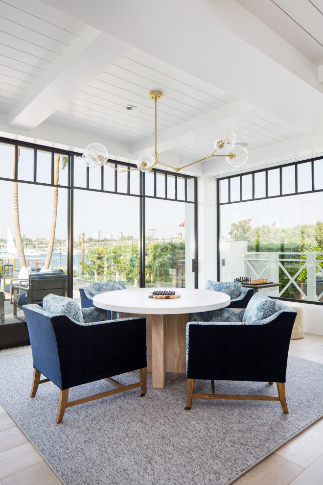 Design ideas for an expansive nautical dining room in Orange County with white walls, light hardwood flooring and beige floors.