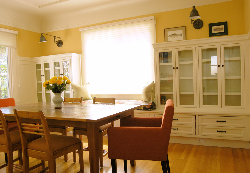 Immagine di una sala da pranzo classica di medie dimensioni e chiusa con pareti gialle e pavimento in legno massello medio