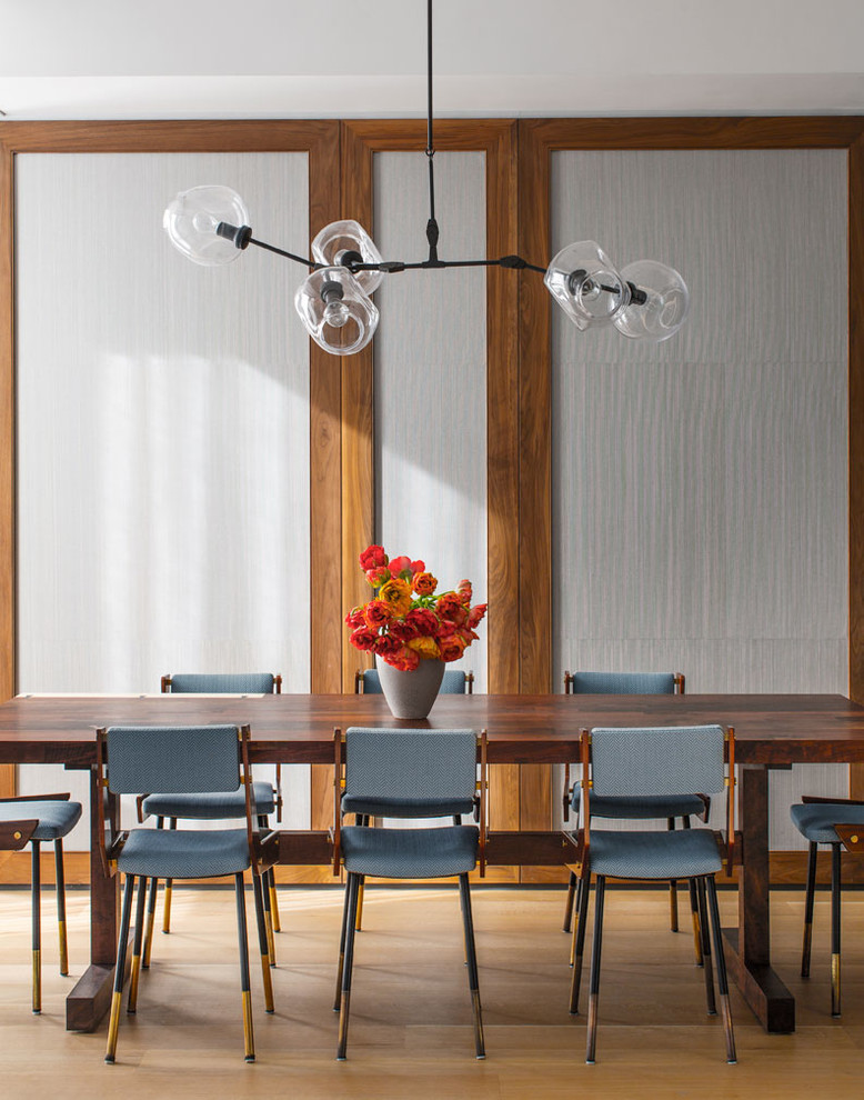Contemporary dining room in New York with medium hardwood flooring.