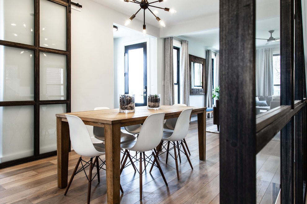 Inspiration for a contemporary medium tone wood floor and brown floor dining room remodel in Indianapolis with white walls