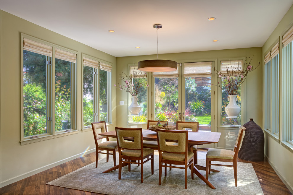 This is an example of a medium sized midcentury kitchen/dining room in San Francisco with green walls, medium hardwood flooring and no fireplace.