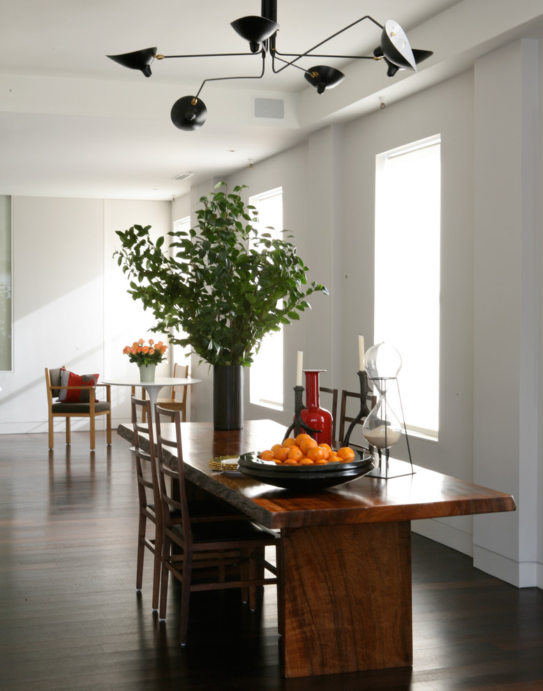 Contemporary dining room in New York with white walls.