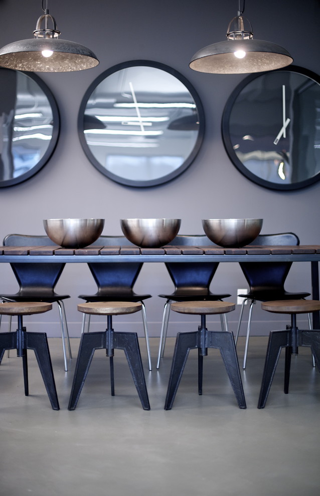 Inspiration for a modern concrete floor dining room remodel in Vancouver with gray walls