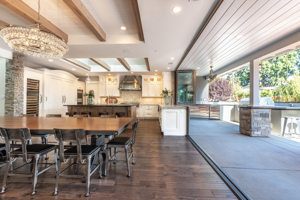 Example of a transitional medium tone wood floor and brown floor dining room design in San Francisco with white walls