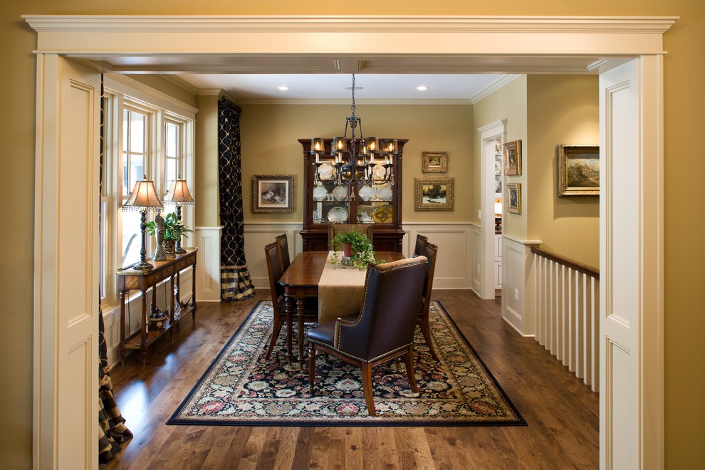 Example of a large classic dark wood floor enclosed dining room design in Minneapolis with green walls