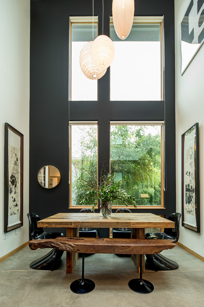 Photo of a world-inspired dining room in Portland with white walls, concrete flooring, no fireplace and grey floors.