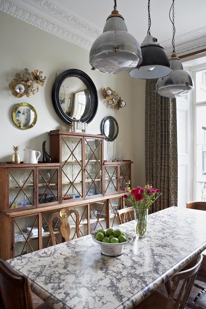 Elegant dining room photo in London with beige walls
