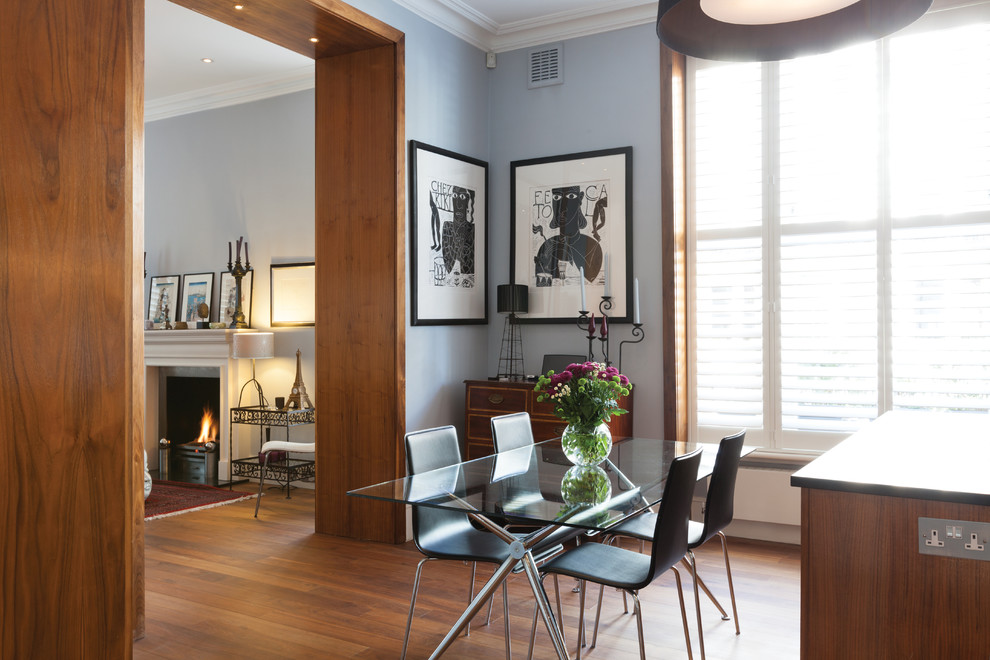 Medium sized bohemian kitchen/dining room in London with blue walls, medium hardwood flooring and brown floors.
